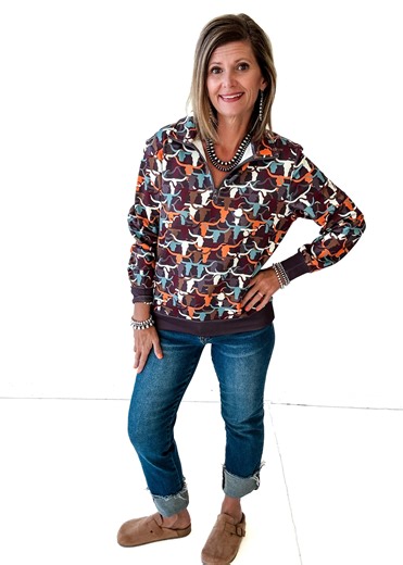 If your everyday life includes roping, riding, stockshow-ing, or just loving all things western… this Scuba Quarter Zip in the Steers print is going to be your new favorite. It’s sleek, stretchy, and soft just like good scuba fabric should be, but with the cutest steer pattern that fits the ranch-life aesthetic perfectly. Lightweight enough for layering, warm enough for cool mornings in the barn, and stylish enough for a day in town. This is the kind of quarter zip that western women wear on rep