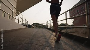 Asian short hair woman athlete running up the stairs training workout exercise male runner legs jogging on steps in urban city background