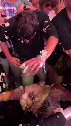 Steve Aoki throws a cake and center a person in full face