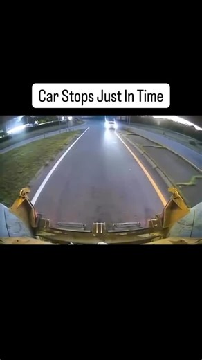 Daily Dose of Injury on Instagram: "The footage is captured from the front of a large piece of industrial machinery, likely a tractor or snowplow, moving slowly along the pavement. Suddenly, a white car traveling at high speed appearing from the opposite direction loses control. The vehicle skids sideways, narrowly missing a direct head-on collision with the heavy machinery by only inches. The car finally screeches to a halt just as it enters the frame, surrounded by a cloud of smoke and debris.