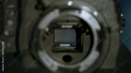 Extreme closeup of mirror shutter operation in 35mm professional film movie camera. Film gate is covered by a ground glass. 4k footage.