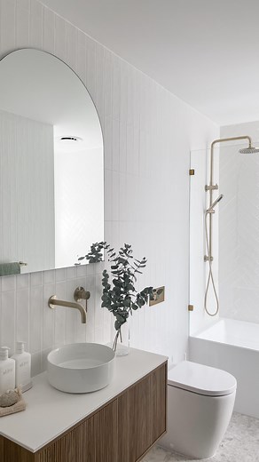 TileCloud on Instagram: "This bathroom has nailed the Minimalist Light style 😍 To create the look our Newport matte white subway tiles have been used on the walls in a herringbone and vertical stack pattern- both with white grout. On the floor is our Stirling in white 🤍"