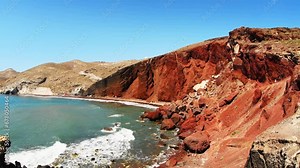 Red beach in Santorini island, Greece. Red volcanic cliffs and the blue sea, black sand on the beach. Beautiful summer landscape. Zoom out