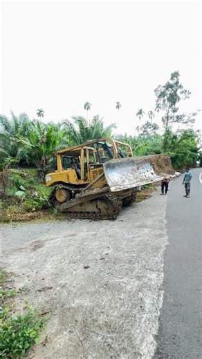 D6R XL Bulldozer Passing on an Asphalt Road