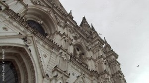 Tilt-up and left pan across upper facade of Cathedral of Santa Ana in San Salvador