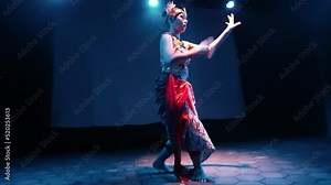 A Java dancer moves her body to the beat while dancing a traditional dance
