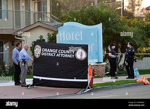 FILE - In this Sept. 23, 2020, file photo, investigators work in front of Hotel Miramar in San Clemente, Calif., after an Orange County sheriff's deputy shot and killed a Black man after he allegedly tried to grab one of their guns during a struggle. Newly released video shows Orange County sheriff's deputies debating whether to stop a homeless man with mental health issues before shooting him during a struggle. The Sept. 23 death of Kurt Reinhold, who was Black, touched off protests and a lawsu