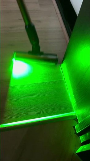 Dyson Gen5 Detect Absolute Vacuum Cleaner. The Fluffy Optic cleaning head emits green light.