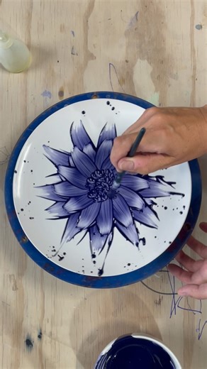 Love in Pottery on Instagram: "Zemer Peled (@zemerpeled) is a ceramic artist, internationally recognized for her powerful porcelain sculptures. Working at the edge of beauty and danger, she uses clay and reconstruction to reflect nature’s complexity—every shard, stroke, and form intentional and bold. Zemer showcases a painterly process on clay: using only brush and cobalt blue underglaze, she brings a blank ceramic plate to life. Each petal unfurls with motion, control, and feeling—proof that po