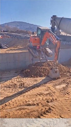 Excavator descending a slope with a significant elevation difference.