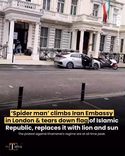 The Tatva on Instagram: "A protester has climbed on to the balcony of the Iranian embassy in central London and pulled down the country’s flag during an anti-regime demonstration. Social media footage appeared to show a man replacing the flag with the pre-Islamic revolution lion and sun flag, often used by opposition groups in the country. The Iranian embassy later posted a picture on its X account of the flag back in place with the caption “Iran’s flag is flying high”. The Metropolitan police s