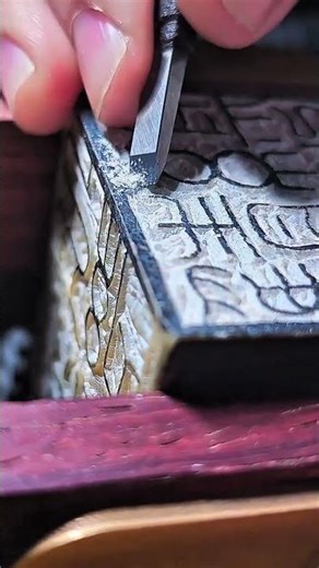 Engraving intricate traditional script patterns onto wooden block
