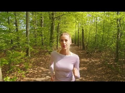 Woman Jogging Through Forest Stock Video