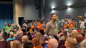 DFL delegates stand silently with their backs turned in protest to hennepin county sheriff dawanna witt as she speaks, unhappy with sheriff deputies collaborating with ICE during operation metro surge and brutalizing protestors
