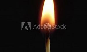 Closeup Match burning and combusting on black background. Match lights up in slow motion arbitrarily from burning air or temperature. No traces of arson. Spontaneous combustion of sulfur .