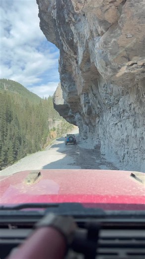 John and Jennifer Schraedel on Instagram: "Nothing like a shelf road with an overhang. This is a cool section of trail on the way to Yankee Boy Basin. It can be a little bit drippy so you may want to close your top. But we sucked it up and went through, top open. Living life dangerously. 🤭 Have you been there? Want to know what’s going on behind the scenes? Join our broadcast channel for a peek at our day to day shenanigans. Thank you for all of your support! We truly appreciate you! 💖💖 Want 