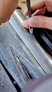 Manually creating a precise knurled texture on a metal surface using a tool