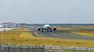 Tow Tractor towing a passenger plane on the runway of the airfield