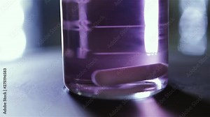 Lab Experiment with Centrifuge Machine. Chemistry Experiment with Purple Water on a Flask in the Lab. Close-Up.