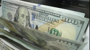 Money counting. Close up currency counting machine counting dollar bills. Machine counter calculates 100 dollars banknotes in slow motion. Closeup currency count machine counting dollar banknotes.