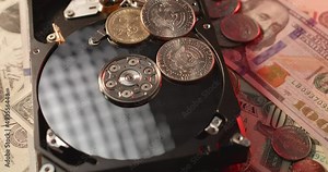 US Dollar coins on top of a Hard drive disk. Cost of computer storage capacity concept. US Eisenhower Dollar and other one and half Dollar coins