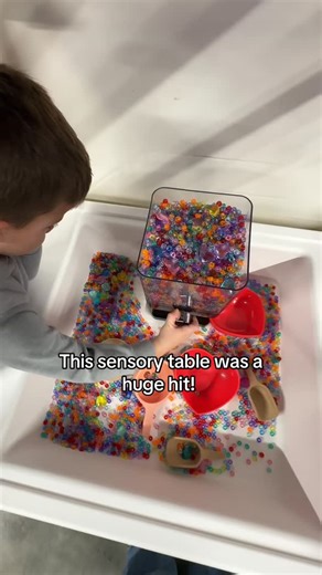 Preschool Vibes on Instagram: "Valentine Sensory Table💗 We filled the table using eight packs of these beads and about ¾ of a heart gem pack, then added heart bowls, scoops, funnels, and a cereal dispenser for pouring and transferring. Simple materials, lots of repetition, and plenty of fine-motor work built right into play."