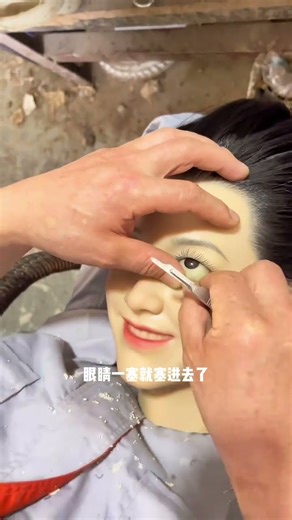 Beautiful wax doll installing eyes. Eyelids are soft and stretchable