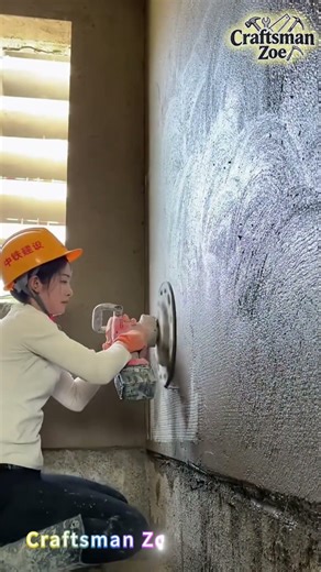 Hand held disc plasterer evenly plasters concrete on the wall