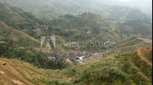 Terraced rice fields and traditional village - Longsheng, Guangxi province, China.