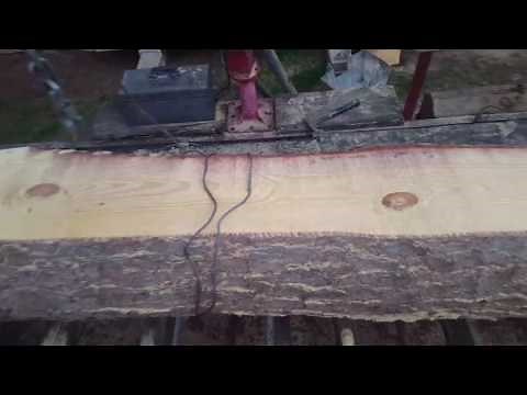 Turning logs on sawmill bed.