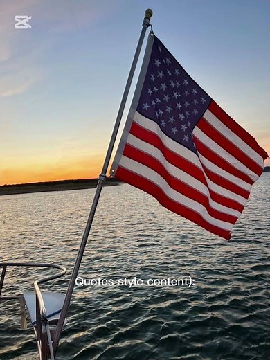 see an American flag flying from a boat at sunset, with calm water and a warm sky