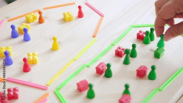 Child and adult enjoy interactive math game with colorful plastic counters and counting sticks, fine motor skills, Early childhood development, Bonding time, Hands-on learning