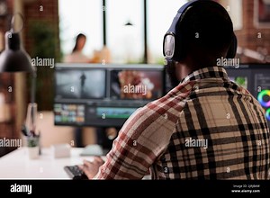 Video editor editing film footage on software, using visual effects and color grading to edit movie for post production content. Creating video montage with professional digital app Stock Photo - Alamy