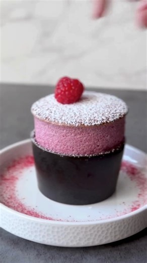 A cloud of raspberry perfection ❤️ This gluten-free soufflé by @fred.csibilevin rises with precision, crafted from @les_vergers_boiron puree and finished with a dusting of sugar and a single fresh raspberry ✨ Light, airy, and baked to impress—this beauty pairs effortlessly with dark chocolate, fruit sauces, or sabayon. Recipe is on @fred.csibilevin's IG post 🔥 • • • Want to be featured on @pastryartsmag profile? Tap our bio link for info.☝ | Pastry Arts: Magazine, Podcast, Summit, Shop & Commun
