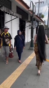An Indonesian girl walks the streets of Jakarta in traditional dress. People seem shocked, as if they have forgotten what their culture was before Islam. | Modi Supporters
