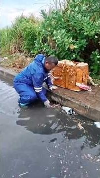 Remove debris that blocked the drain after heavy rain caused the road to flood #unclogged #unclog