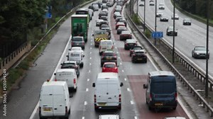 Heavy, slow moving morning rush hour motorway traffic. Blurred, real time.