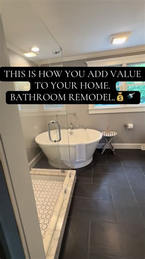 One of the best ways to add value to your home without adding square footage is by updating the bathroom. This one got a full makeover with a new stand-up shower, a soak-in tub, granite countertops, built-in cabinets/storage, and a sleek barn door. #bostonhomes #bathroommakeover #bathroomremodel #barndoor #soakingtub