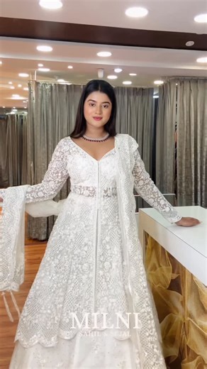 MILNI on Instagram: "Draped in timeless white, where elegance whispers and grace shines effortlessly 🤍✨ Ivory anarkali, white ethnic wear, lace detailing, sheer dupatta, festive couture, modern traditional, statement necklace, graceful silhouette, bridal vibes, luxury fashion #WhiteElegance #IvoryAnarkali #EthnicWear #IndianFashion #FestiveLook #BridalVibes #GraceInWhite #LuxuryEthnic #DesignerWear #TraditionalWithATwist #AnarkaliLove"
