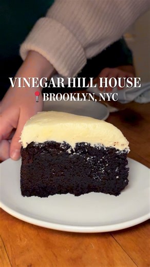 Food52 on Instagram: "Today on The Perfect Order, Justin and Noah stop by @vinegarhillhouse. Their perfect order starts with the Vinegar Hill, followed by a crisp little gem salad and a rich chicken liver mousse. Then a red wattle pork chop over jalapeño-cheddar grits and Guinness chocolate cake to finish."
