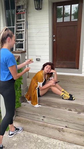 Girl pops a party popper on friend