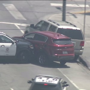 An LAPD cruiser rammed a stolen vehicle in a pursuit, pushing the SUV in a circle until it hit another vehicle and then a curb in the South L.A. area Thursday. The driver exited through a window and was taken into custody by police shortly after. http://on.ktla.com/yxUiP | KTLA 5 News