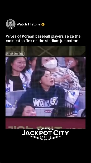 @watchhistory on Instagram: "(321) At a Korean baseball game, when the camera lands on players’ wives in the stands for a “kiss cam” or fan shot, they seize the moment. Instead of a shy wave, they strike exaggerated, confident, model-like poses—“flexing” their style and composure for the giant screen. It’s a hilarious and empowering subversion, turning the male-gaze tradition into a showcase of their own star power. This is a cultural power move. These women, often in the public eye themselves, 