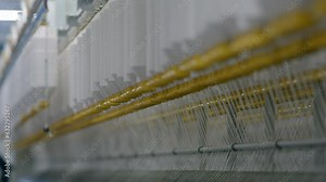 cotton thread textile factory, cinematic, shallow focus depth, Organic cotton yarn used for sustainable eco-friendly cotton yarns fabric decentralised production. Industrial, clean, 4K, machine,