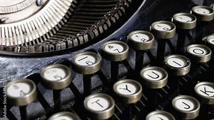 Camera moves on a old black vintage manual typewriter keyboard