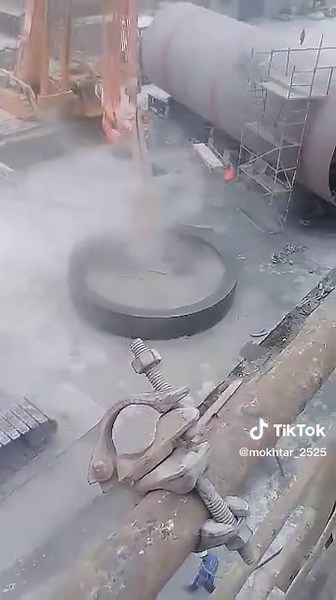 Crane Lifts Heavy Metal Structure at Construction Site