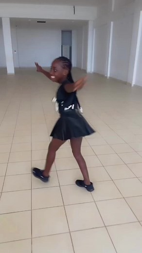 Young Girl's Stylish Dance Moves in a Spacious Setting