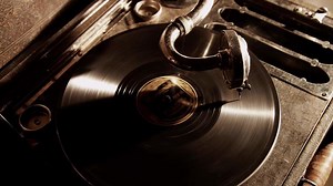 Download Dark static shot of classic record player with light behind and hard shadows in 4K for free