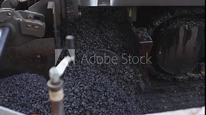 Process of asphalting, blacktopping and paving, asphalt paver machine and steam roller compactor during construction and repairing works, workers on the construction site, rental vehicle working