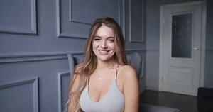 clip-3596290769-attractive-woman-playfully-smiling-camera